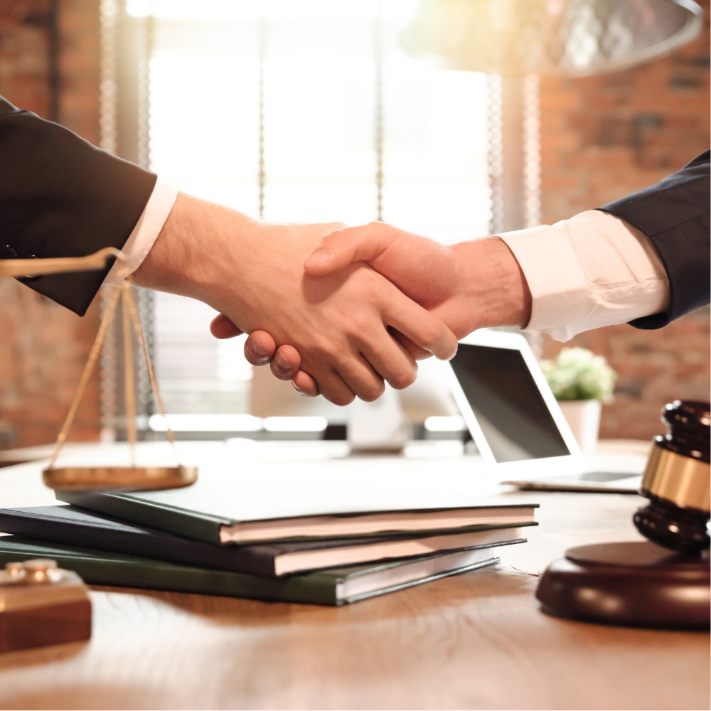 A person holding hands with a lawyer, symbolizing support and guidance through the legal system.